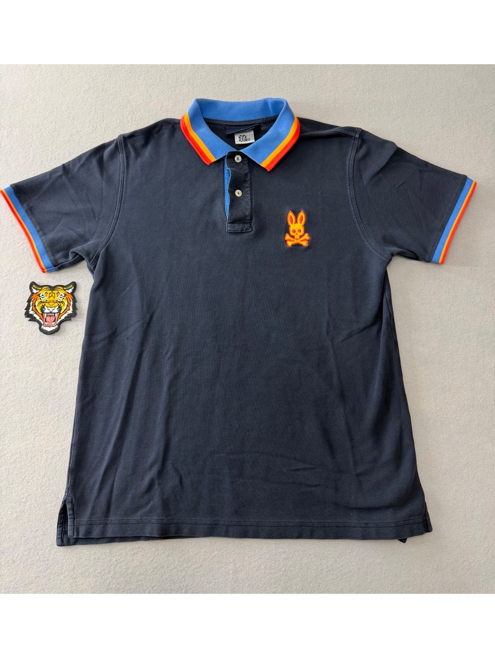 257/857 Psycho Bunny Men’s Polo Shirt Small Navy Blue Rainbow Trim Skull Logo